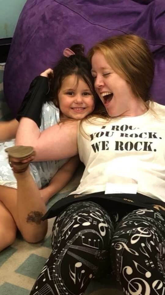 A baby and a girl smiling